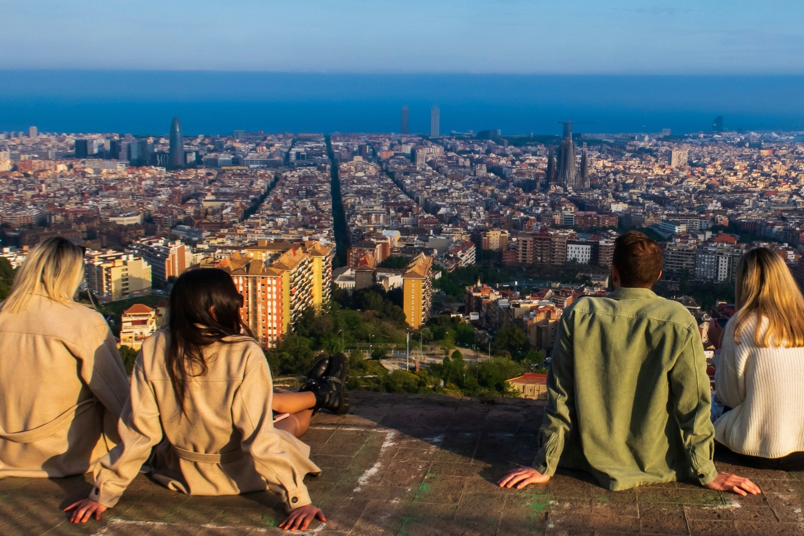 Four students sitting on a rooftop overlooking Barcelona
