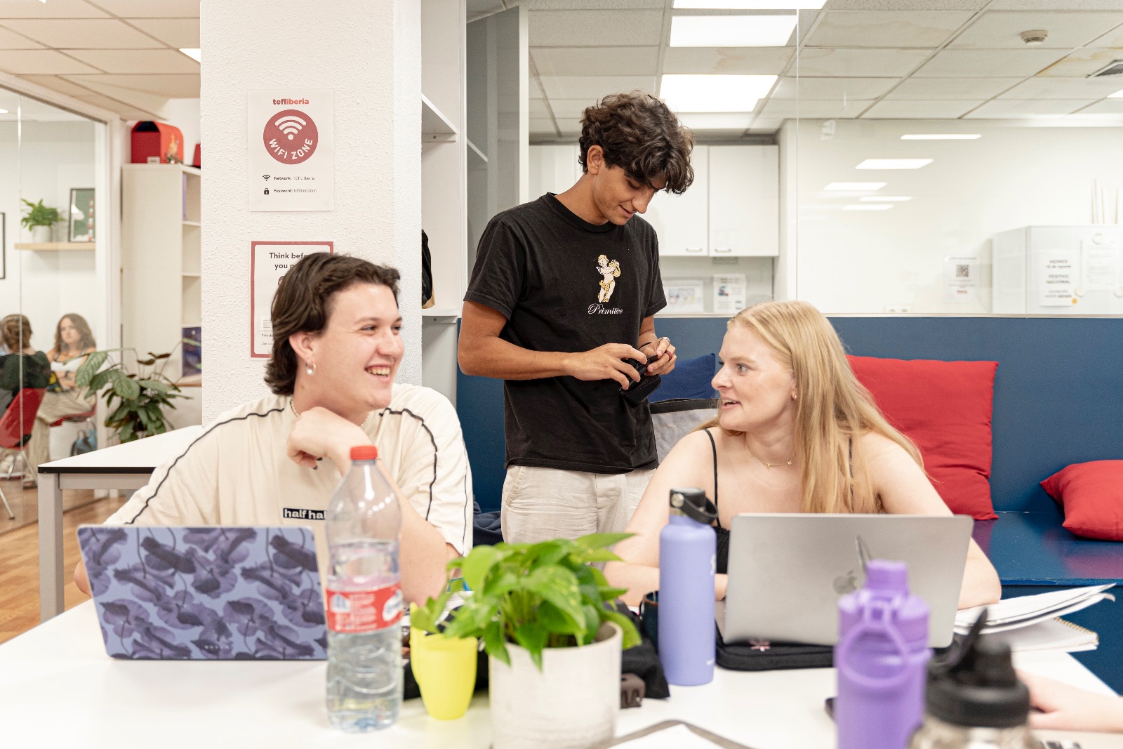 Two students happily chatting at Iberia Language Academy